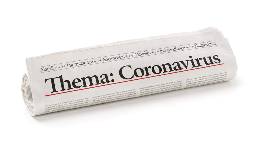 Zeitungsrolle mit der Überschrift Coronavirus