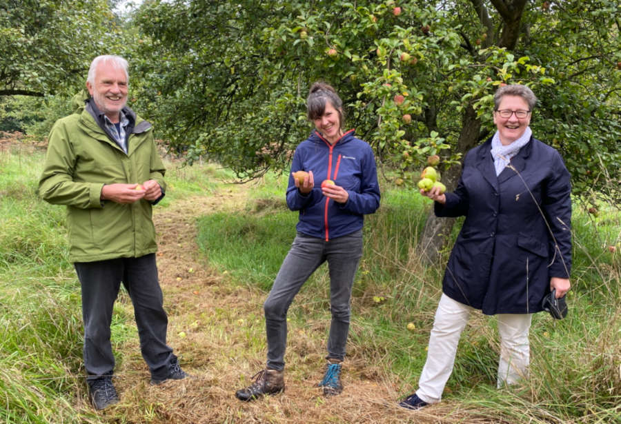 Obstbaumwartin Vanessa Kowarsch (Mitte) zeigt Jürgen Georgi und Dr. A. Heinrike Heil die Besonderheiten der alten Sorten auf der Streuobstwiese.