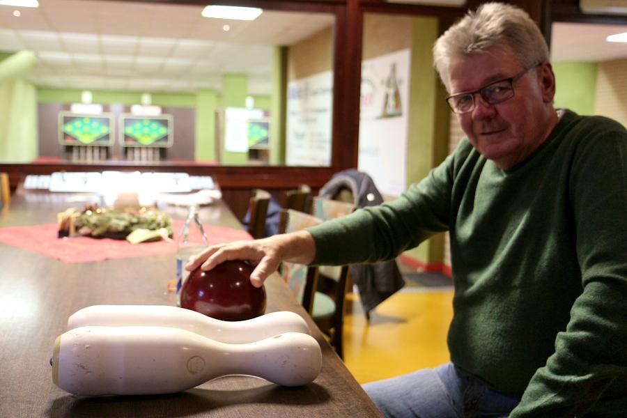 Walter Knörrich sitzt am Tisch der Bahn der Sportkegler Greste. Vor ihm liegen zwei Kegel und eine Kugel, die ihre Lebenszeit hinter sich haben. Foto: Thomas Dohna