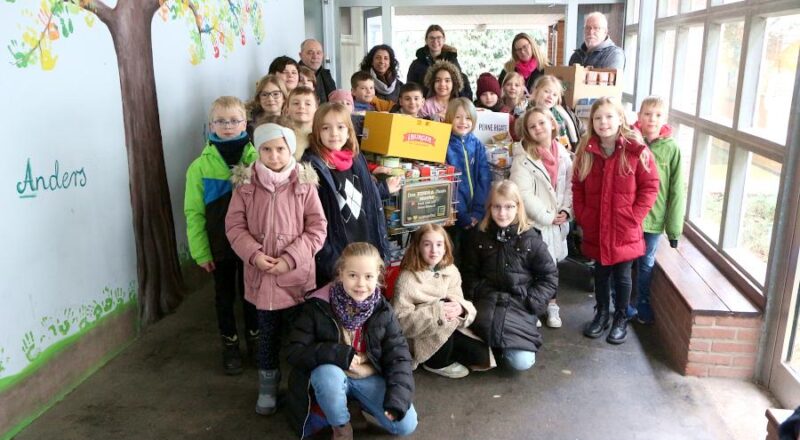 Die Kinder des Kinder Parlaments der Grundschule Asemissen übergaben den Inhalt von sechs Einkaufswagen an Peter Schindler (rechts hinten) und Günther Röttges (links hinten) von der Tafel. Mit dabei waren Celina Seemann, Marian Labib und Manuela Knoche, alle von der Grundschule. Foto: Thomas Dohna