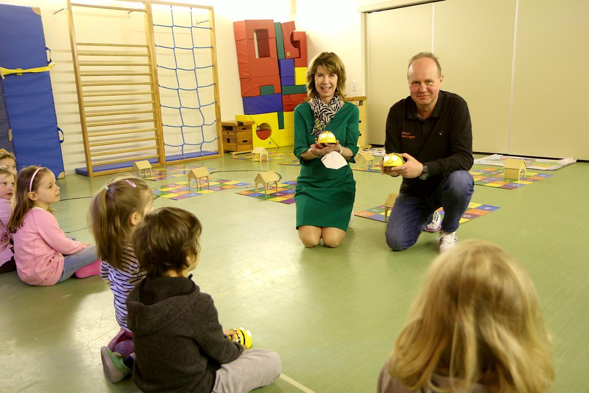 Martina Schwartz-Gehring von der Osthushenrich-Stiftung und Reinhard Stückerjürgen zeigen zwei der programmierbaren Bienen, mit denen sich die Kinder der Tagesstätte Arche in dieser Woche beschäftigen. Foto: Thomas Dohna