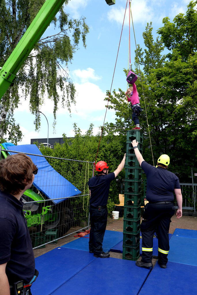 Oben angekommen: Friederike Pott hat ihren Kistenturm erfolgreich aufgebaut und kann sich jetzt aus dem Süßigkeitenbeutel, der in luftiger Höhe hängt, eine Belohnung nehmen. Foto: Edeltraud Dombert