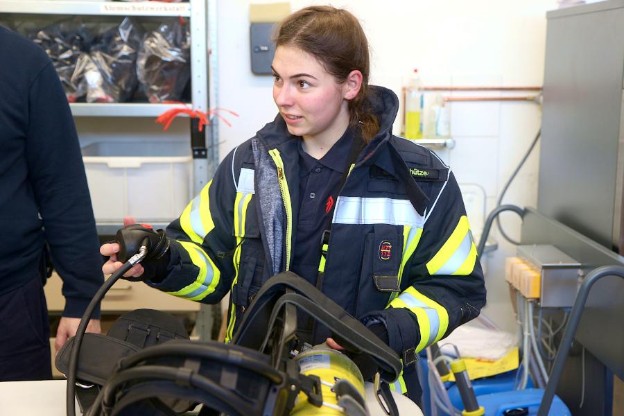 Julie Schütze hält den Lungenautomaten. In dem ist ein Ventil, über das die Atemluft in die Maske strömt. Foto: Thomas Dohna