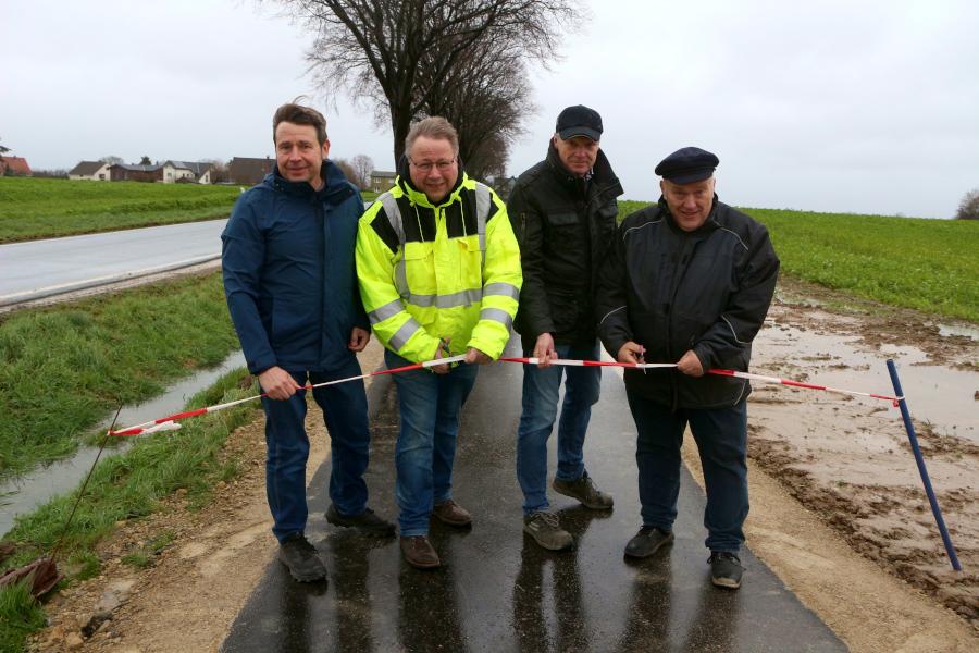 Christian Kühnel, Thomas Jahn, Berna Hamann und Andreas Brinkmann eröffnen bei Wind und Wetter den neuen Bürgergehweg an der Straße Krentruperhagen. Foto: Thomas Dohna