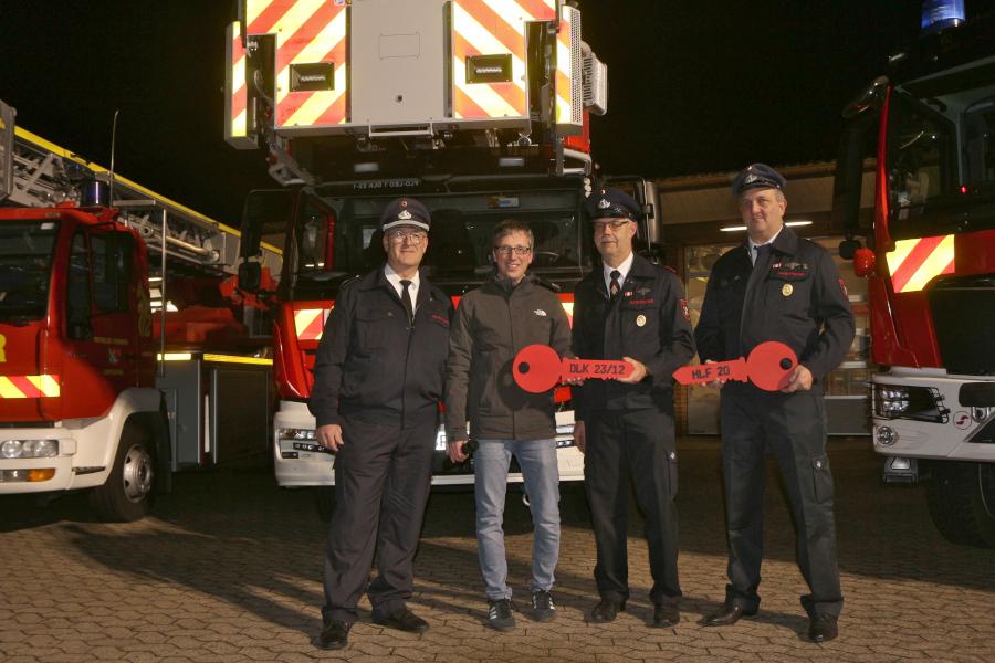 Der Leiter der Feuerwehr Leopoldshöhe Harald Schubert (links), Bürgermeister Martin Hoffmann und die Fahrzeugpfleger Jens Seidensticker für die neue Drehleiter und Sebastian Friedemann für das neue HLF. Foto: Thomas Dohna